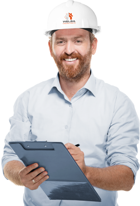 Man wearing a white safety helmet and light blue shirt, holding a clipboard and pen, smiling at the camera.